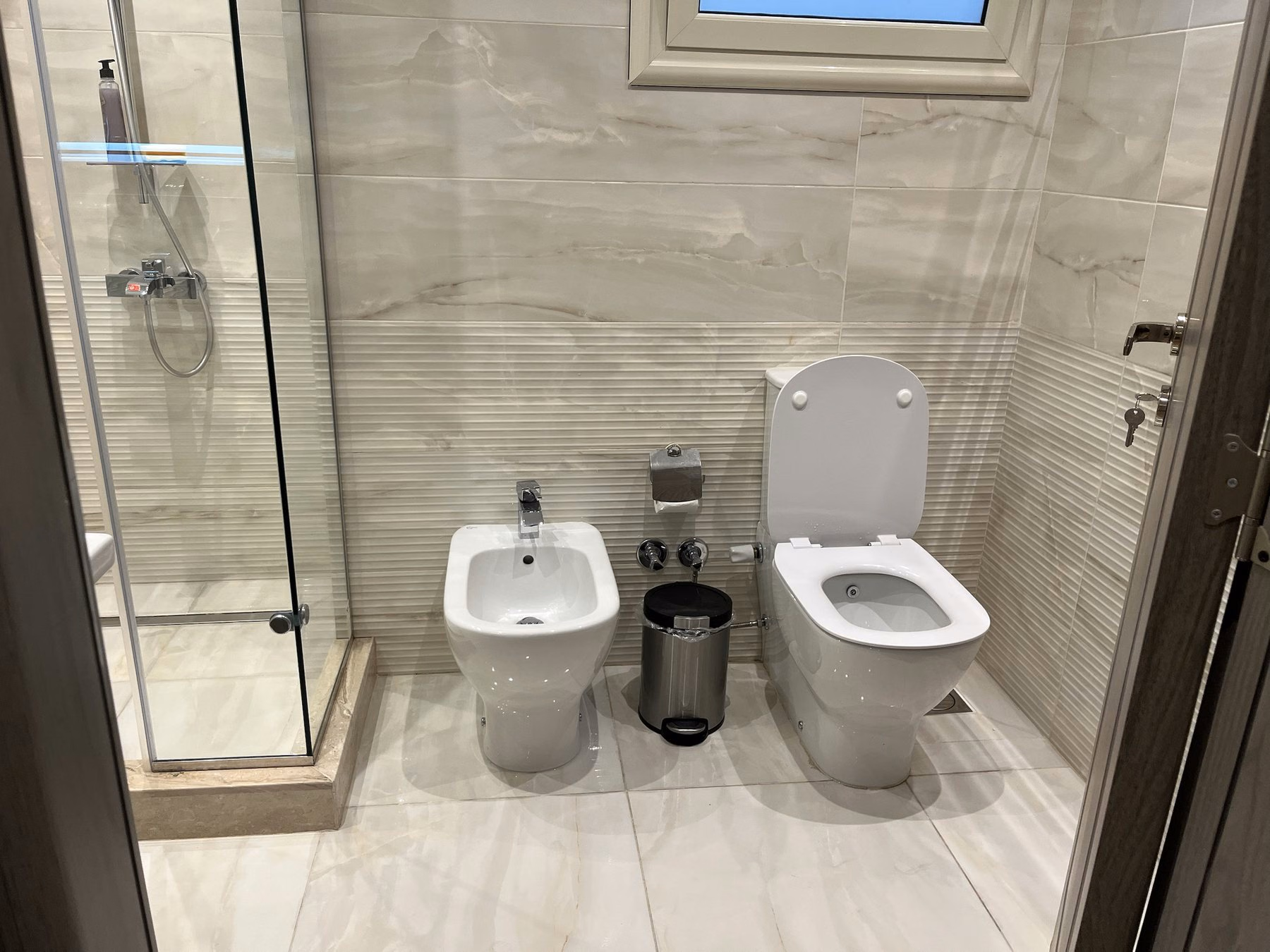 Bathroom with shower enclosure and bidet